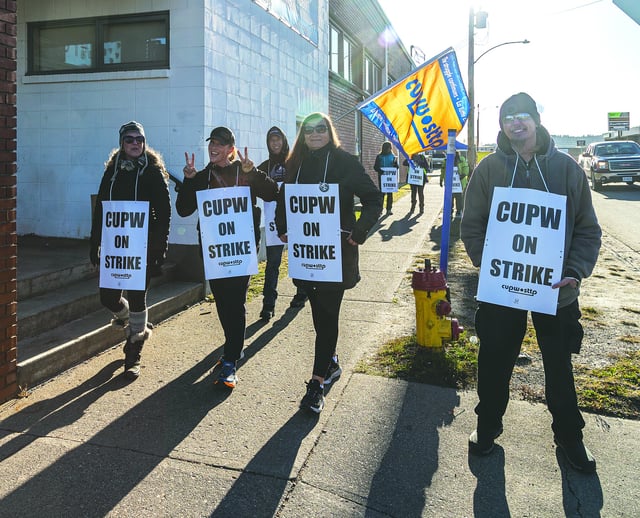 Prince George Canada Post workers walk a picket line on Fifth Avenue near Nicholson Street during their last strike in November 2024.
