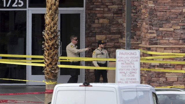 Las Vegas Metro Police officers are shown by the main entrance of a Las Vegas Athletic Club after a shooting Friday, May 16, 2025. 2025, in Las Vegas. 
