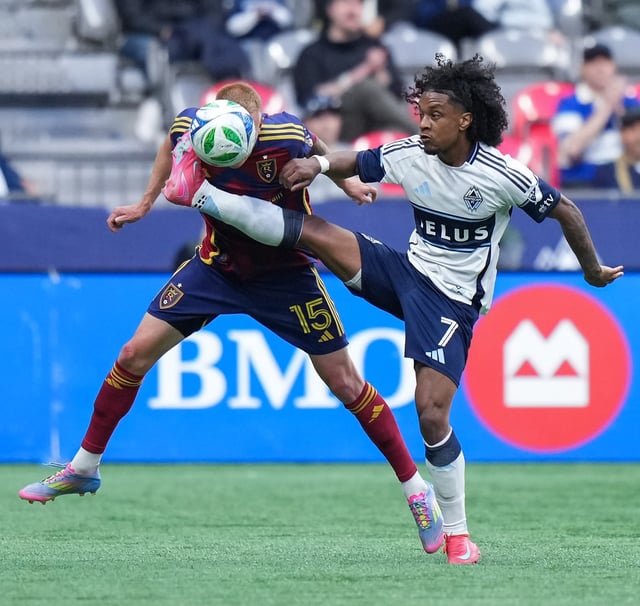 Vancouver Whitecaps' Jayden Nelson (7) and Real Salt Lake's Justen Glad (15) vie for the ball during the first half of an MLS soccer match, in Vancouver, on Saturday, May 3, 2025. THE CANADIAN PRESS/Darryl Dyck