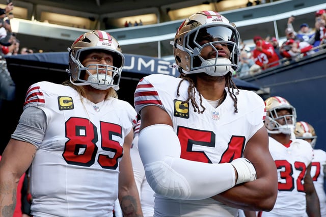 FILE: George Kittle (left) and Fred Warner of the San Francisco 49ers look on before the game against the Seattle Seahawks at Lumen Field on Oct. 10, 2024, in Seattle.