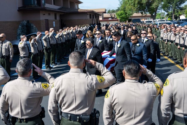 Law enforcement personnel salute as the casket containing Los Angeles County Sheriff’s Deputy Alfredo “Freddy” Flores is brought in to St. Didacus Catholic Church in Sylmar on Thursday, May 9, 2024. Flores was severely injured in an Oct. 2023 fire at a mobile shooting range at the Pitchess Detention Center in Castaic and died on April 20.  (Photo by Hans Gutknecht, Los Angeles Daily News/SCNG)