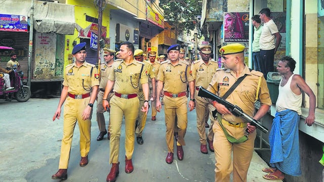 Police carry out a march in Sambhal on Monday. (PTI)