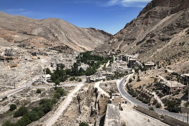 Aerial view of the nearly dry Ein el-Fijeh spring in the Barada Valley, Syria, Thursday, May 8, 2025. As the main water source for Damascus, its depletion has forced many residents in the capital and surrounding suburbs to rely on water from tanker trucks that draw from local wells.(AP Photo/Ghaith Alsayed)