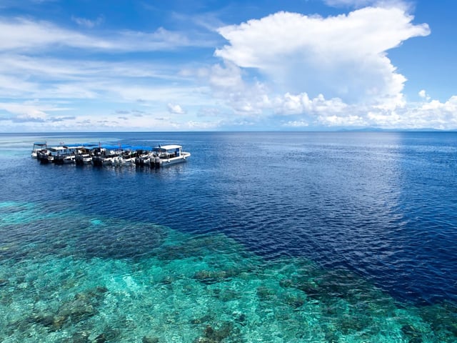 Boats at dive site off of the coast of Sipadan Island in Sabah, Malaysia. Photo: Shutterstock