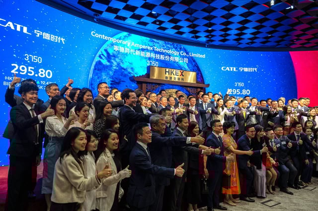 Guests pose for photographs at the listing ceremony of Contemporary Amperex Technology Co. (CATL) in Hong Kong, Tuesday, May 20, 2025. (AP Photo/Chan Long Hei)