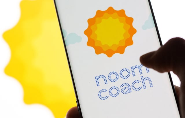 Smartphone with Noom logo is seen in front of displayed same logo in this illustration taken, July 13, 2021. REUTERS/Dado Ruvic/Illustration/File Photo