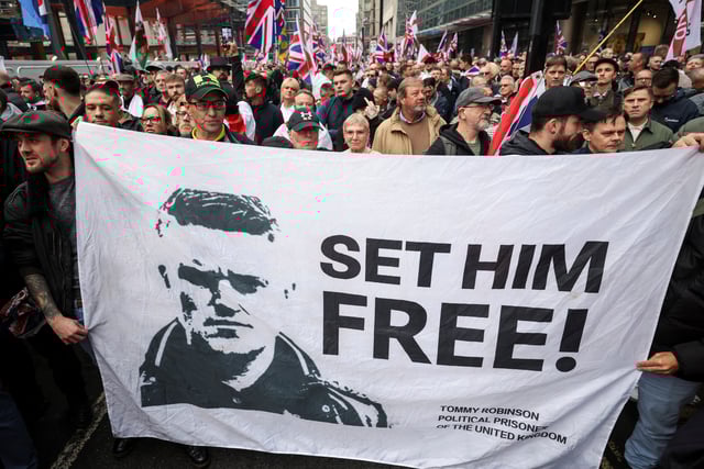 People carry a banner in support of Stephen Yaxley-Lennon, a British anti-Muslim activist known as Tommy Robinson, during an anti-immigration protest, in London, Britain, October 26, 2024. REUTERS/Hollie Adams/File Photo