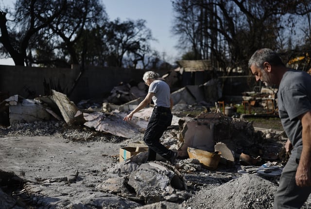 Anna Schlobohm de Cruder (C) and Daniel Cruder search through the remains of Anna&#39;s home which was destroyed in the Eaton Fire on March 20, 2025, in Altadena, California.