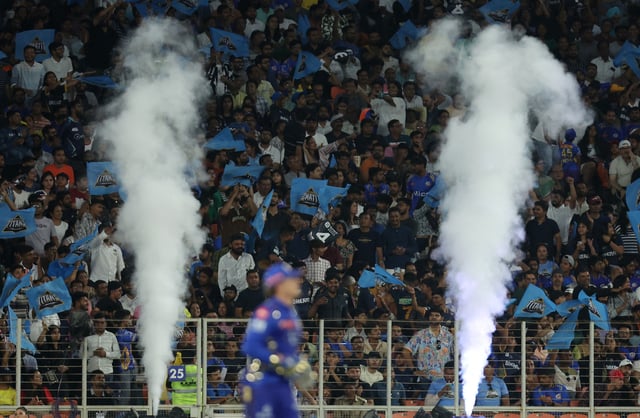 Cricket - Indian Premier League - IPL - Gujarat Titans v Mumbai Indians - Narendra Modi Stadium, Ahmedabad, India - March 29, 2025 Gujarat Titans fans celebrate six runs scored by Jos Buttler REUTERS/Amit Dave/File Photo