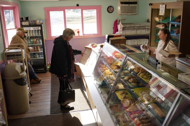 FILE - A customer selects donuts at Leavitt's Country Bakery, in this April 13, 2023, file photo in Conway, N.H. (AP Photo/Robert F. Bukaty, file)
