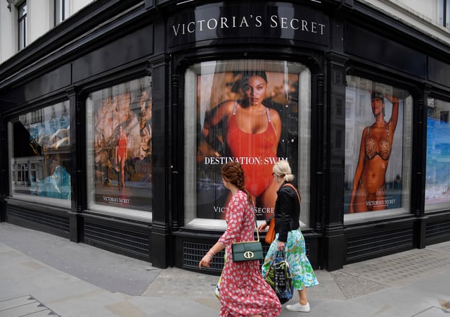 People pass a window display at a branch of Victoria's Secret in New Bond Street in London, Britain, March 31, 2021. REUTERS/Toby Melville/File Photo