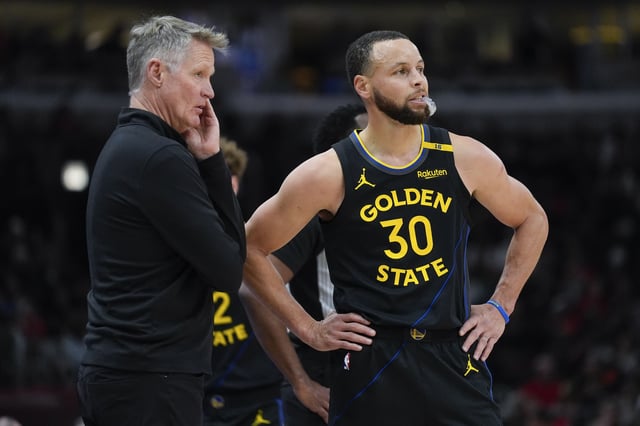Golden State Warriors head coach Steve Kerr, left, talks with Warriors guard Stephen Curry (30) during the first half of an NBA basketball game against the Chicago Bulls, Saturday, Feb. 8, 2025, in Chicago. (AP Photo/Erin Hooley)