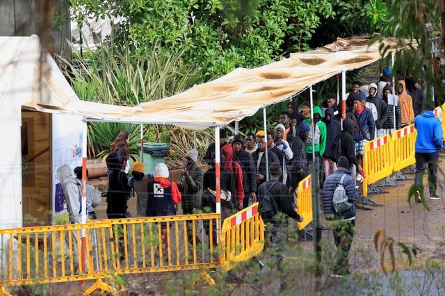 Migrants line up to eat at the Las Raices migrant camp in La Laguna, on the island of Tenerife, Spain, October 27, 2024. REUTERS/Borja Suarez/File Photo