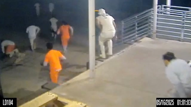A screen grab taken from a handout CCTV video shows inmates running through the loading dock at the Orleans Parish Justice Center, in New Orleans, Louisiana, U.S., May 16, 2025. Orleans Parish Sheriff's Office/Handout via REUTERS/File Photo