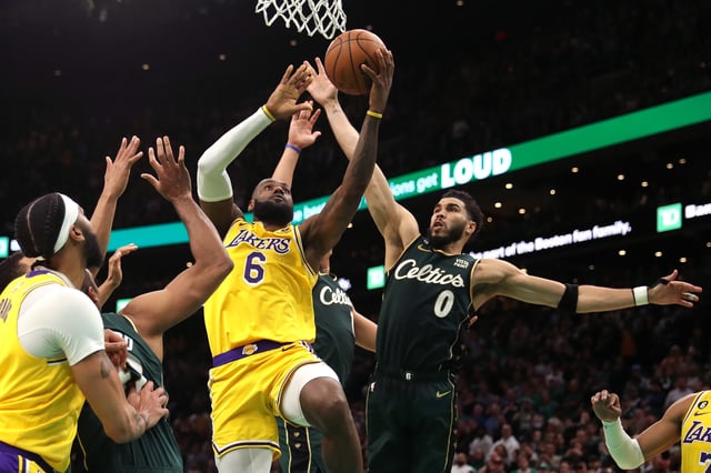 Jayson Tatum #0 of the Boston Celtics defends LeBron James #6 of the Los Angeles Lakers in the final shot of regulation play during the fourth quarter. The Lakers would lose this game.