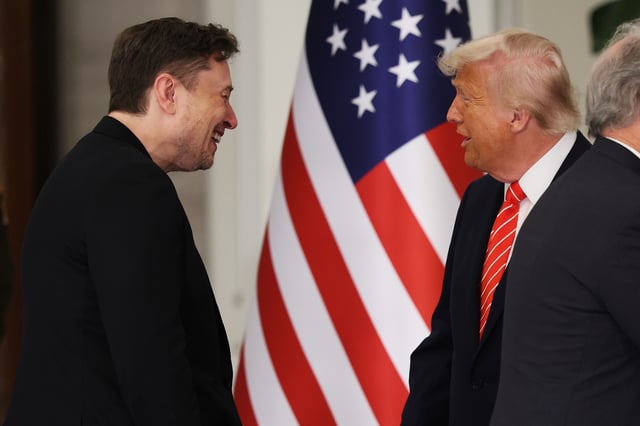 U.S. President Donald Trump greets Tesla CEO Elon Musk before a state dinner at the Lusail Palace on May 14, 2025, in Doha, Qatar.