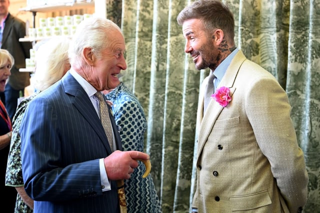 LONDON, ENGLAND – MAY 20: David Beckham wearing a David Austin Roses “King’s Rose” speaks with King Charles III, patron of the Royal Horticultural Society at the Highgrove stand during a visit to the RHS Chelsea Flower Show at Royal Hospital Chelsea on May 20, 2025 in London, England. (Photo by Paul Grover – WPA Pool / Getty Images)