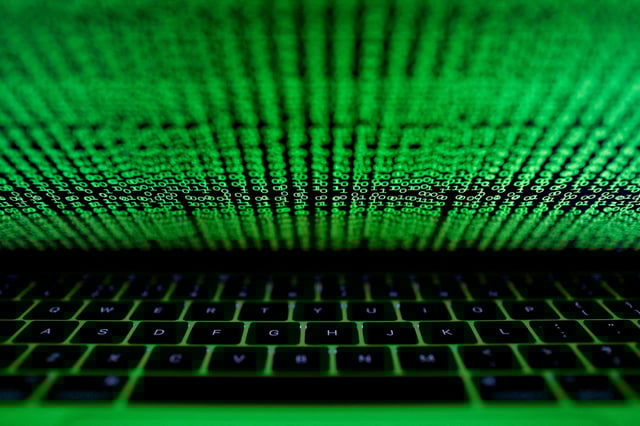 A computer keyboard lit by a displayed cyber code is seen in this illustration picture taken on March 1,  2017. REUTERS/Kacper Pempel/Illustration/File Photo