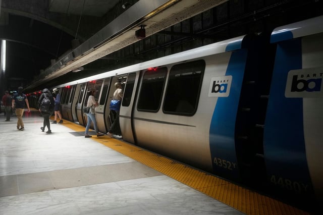 Passengers walk on and off a BART train in San Francisco on May 9, 2025.
