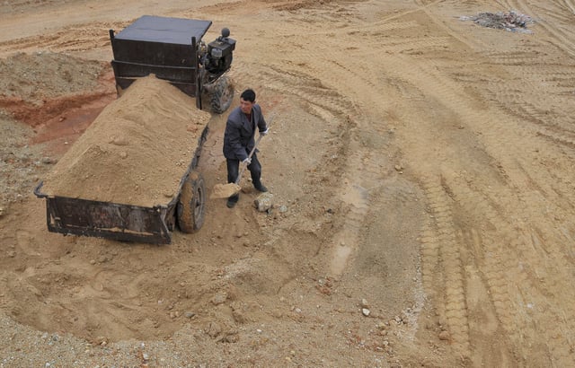 A labourer works at a site of a rare earth metals mine at Nancheng county, Jiangxi province March 14, 2012. REUTERS/Stringer/File Photo