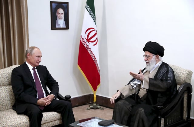 In this picture released by an official website of the office of the Iranian supreme leader, Supreme Leader Ayatollah Ali Khamenei, right, speaks with Russia&#39;s President Vladimir Putin, in Tehran, Iran, Friday, Sept. 7, 2018. A portrait of the late Iranian revolutionary founder Ayatollah Khomeini hangs on the wall.