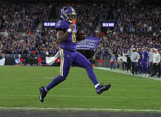 Ravens quarterback Lamar Jackson scores a two-point conversion against the Bengals in the fourth quarter. Ravens defeated the Bengals 35-34 at  M&amp;T Bank Stadium. (Staff)