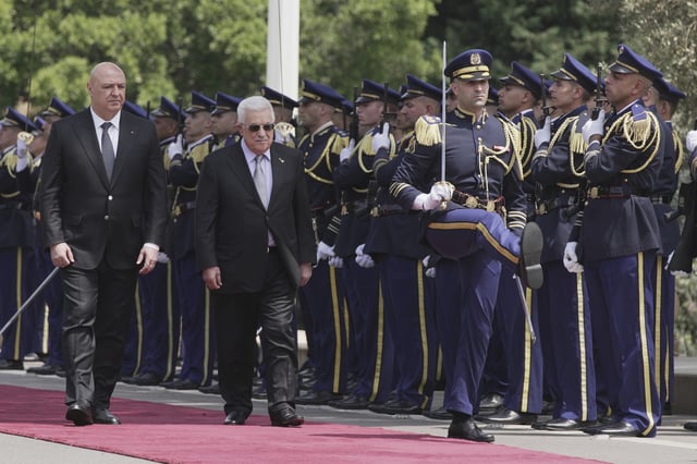 Lebanese President Joseph Aoun, left, and Palestinian President Mahmoud Abbas, center, review an honor guard at the Presidential Palace, in Baabda, east of Beirut, Lebanon, Wednesday, May 21, 2025. (AP Photo/Hassan Ammar)