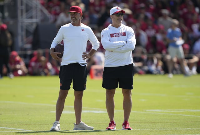 SANTA CLARA, CALIFORNIA - JULY 29: Head coach Kyle Shanahan (L) and General manager John Lynch (R) of the San Francisco 49ers looks on during training camp at SAP Performance Facility on July 29, 2024 in Santa Clara, California. (Photo by Thearon W. Henderson/Getty Images)