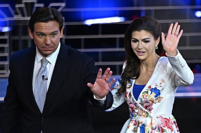 Florida Governor Ron DeSantis (L) and his wife Casey DeSantis wave as they depart the third Republican presidential primary debate at the Knight Concert Hall at the Adrienne Arsht Center for the Performing Arts in Miami, Florida, on November 8, 2023