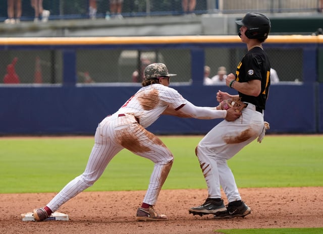 May 20, 2025; Hoover, AL, USA; Alabama shortstop Justin Lebron (1) tags out Missouri’s Kaden Peer after Peer got caught off first in a pickoff in the first game of the SEC Baseball Tournament at the Hoover Met.