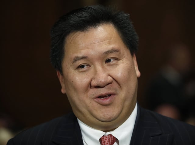James Ho talks to family members before a Senate Judiciary Committee hearing on nominations on Capitol Hill in Washington, Wednesday, Nov. 15.