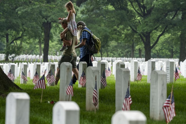 FILE - Families visit Section 60 of Arlington National Cemetery, in Arlington, Va., Monday, May 27, 2024, in honor of Memorial Day. (AP Photo/Jacquelyn Martin, File)