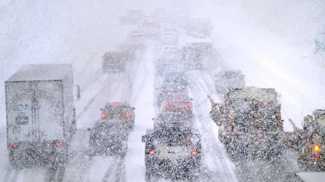 FILE - Plows, at right, try to pass nearly stopped traffic, due to weather conditions, on Route 93 South, March 14, 2023, in Londonderry, N.H. (AP Photo/Charles Krupa, file)