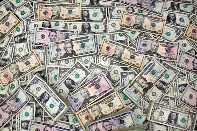 U.S. dollar banknotes are seen in this photo illustration taken February 12, 2018. REUTERS/Jose Luis Gonzalez/Illustration/File Photo