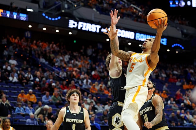 Mar 20, 2025; Lexington, KY, USA; Tennessee Volunteers guard Zakai Zeigler (5) shoots the ball against Wofford Terriers guard Corey Tripp (10) during the first half in the first round of the NCAA Tournament at Rupp Arena. Mandatory Credit: Jordan Prather-Imagn Images