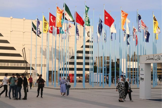 Visitors enter the SINEX Syrian Industrial Expo, a showcase of Syrian companies and products, in Damascus, Syria, May 8, 2025.
