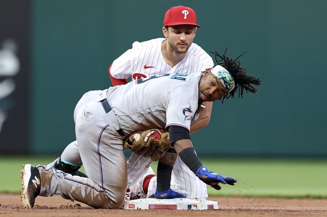 PHILADELPHIA, PENNSYLVANIA - APRIL 11: Trea Turner #7 of the Philadelphia Phillies forces out Jean Segura #9 of the Miami Marlins during the second inning at Citizens Bank Park on April 11, 2023 in Philadelphia, Pennsylvania.