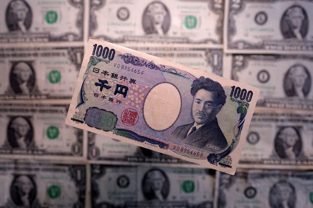 Yen and U.S. dollar banknotes are seen in this illustration taken March 19, 2025. REUTERS/Dado Ruvic/Illustration/File Photo