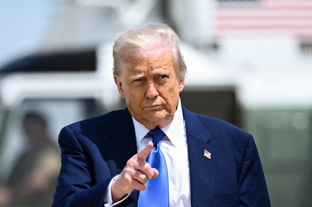 President Donald Trump is seen gesturing as he walks to board Air Force One at Joint Base Andrews in Maryland on May 12, 2025. (Photo by Brendan SMIALOWSKI / AFP) (Photo by BRENDAN SMIALOWSKI/AFP via Getty Images)