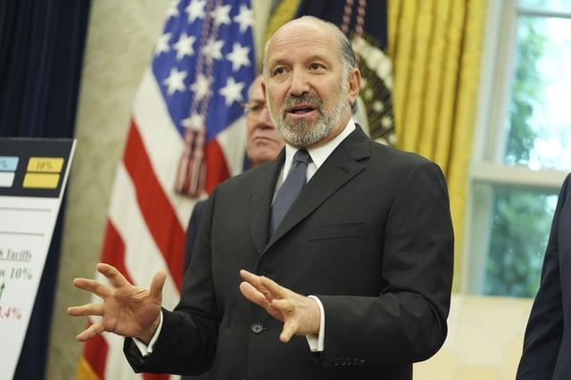 Commerce Secretary Howard Lutnick, left, speaking as a trade deal with United Kingdom in announced in the Oval Office of the White House, Thursday, May 8, 2025, in Washington. (AP Photo/Evan Vucci)