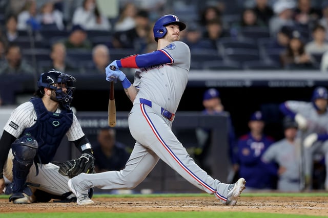 May 20, 2025; Bronx, New York, USA; Texas Rangers catcher Jonah Heim (28) follows through on a double against the New York Yankees during the fifth inning at Yankee Stadium. Mandatory Credit: Brad Penner-Imagn Images