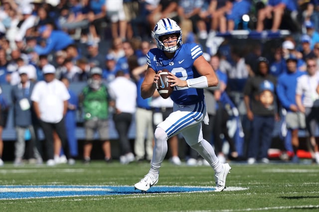 Oct 12, 2024; Provo, Utah, USA; Brigham Young Cougars quarterback Jake Retzlaff (12) rolls out for a pass against the Arizona Wildcats during the first quarter at LaVell Edwards Stadium. Mandatory Credit: Rob Gray-Imagn Images/File Photo