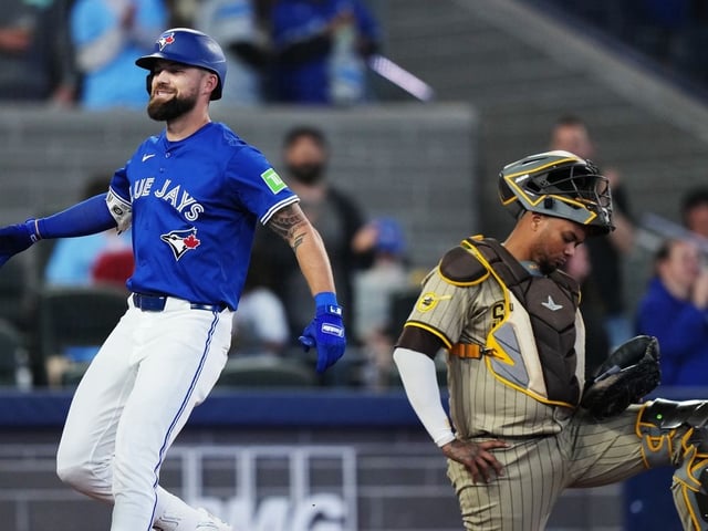 Toronto Blue Jays' Nathan Lukes (left) celebrates his two-run home run as San Diego Padres catcher Martin Maldonado (15) reacts during fifth inning MLB baseball action in Toronto on Wednesday, May 21, 2025.