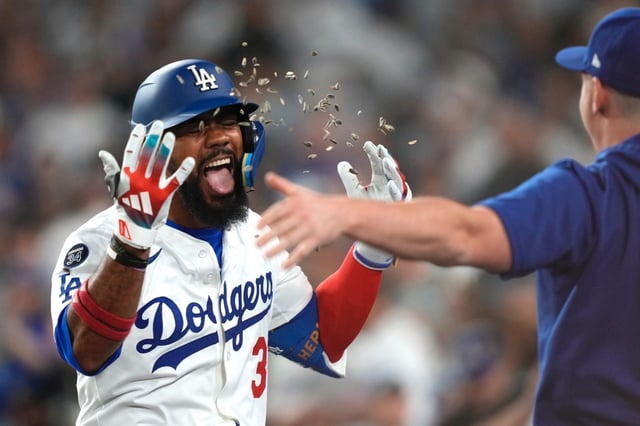 The Dodgers’ Teoscar Hernández, left, is greeted by teammate Will Smith as he returns to the dugout after hitting a go-ahead three-run home run during the sixth inning of their game against the Arizona Diamondbacks on Wednesday night at Dodger Stadium. (AP Photo/Mark J. Terrill)