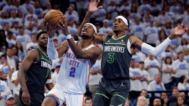 Oklahoma City Thunder guard Shai Gilgeous-Alexander (2) drives against Minnesota Timberwolves forward Jaden McDaniels (3) in the fourth quarter during game one of the western conference finals for the 2025 NBA Playoffs at Paycom Center.
