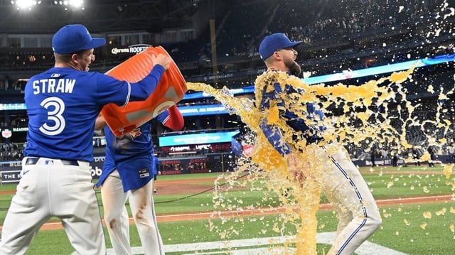 May 21, 2025; Toronto, Ontario, CAN;  Toronto Blue Jays left fielder Nathan Lukes (38) is doused with sport drink after a win over the San Diego Padres at Rogers Centre. Mandatory Credit: Dan Hamilton-Imagn Images