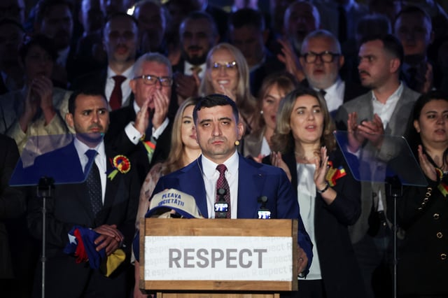 Presidential candidate George Simion reacts to first exit polls of Romania's second round of the presidential election, in front of the parliament in Bucharest, Romania, May 18, 2025. REUTERS/Louisa Gouliamaki/File Photo