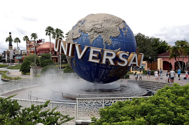 FILE – In this Aug. 5, 2019 file photo, guests cool off under a water mist by the globe at Universal Studios City Walk at Universal Studios Florida in Orlando, Fla. In the wake of the coronavirus crisis, the company that owns Universal theme parks around the world says it’s delaying construction on a fourth theme park in Florida and that the opening of a Nintendo-themed park in Japan will be pushed back by a few months.
Comcast CEO Brian Roberts said Thursday, April 30, 2020 that the company was delaying construction on its fourth park at Orlando Universal Resort. The Epic Universe theme park was announced last year to great fanfare. 