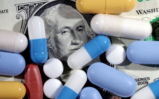 U.S. dollar banknote and medicines are seen in this illustration taken, June 27, 2024. REUTERS/Dado Ruvic/Illustration/File Photo