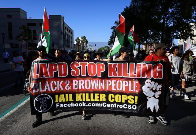 Demonstarters walk carrying a banner and Palestinian flags as Black Lives Matter activists and supporters gather to mark the fifth anniversary of the May 25, 2020 Minneapolis murder of George Floyd, in Los Angeles, California, U.S. May 21, 2025. REUTERS/David Swanson/File Photo